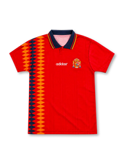 Spain 1994 red home jersey featuring adidas branding, Spanish national crest, navy-and-gold geometric side graphics, and a striped polo collar, front view.