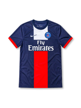 Paris Saint-Germain 2013/14 navy home jersey featuring red-and-white central panels, Nike Swoosh, PSG crest, and Fly Emirates sponsor, front view.