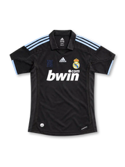Real Madrid 2009/10 black away jersey featuring pale-blue adidas shoulder stripes, white bwin.com sponsor, and crowned club crest, front view.