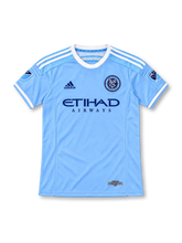 New York City FC 2015 sky-blue home jersey with white adidas shoulder stripes, Etihad Airways sponsor, NYCFC crest, MLS sleeve patches, and inaugural season label, front view.