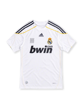 Real Madrid 2009/10 white home jersey with navy adidas stripes, gold trim, club crest and black bwin.com sponsor.