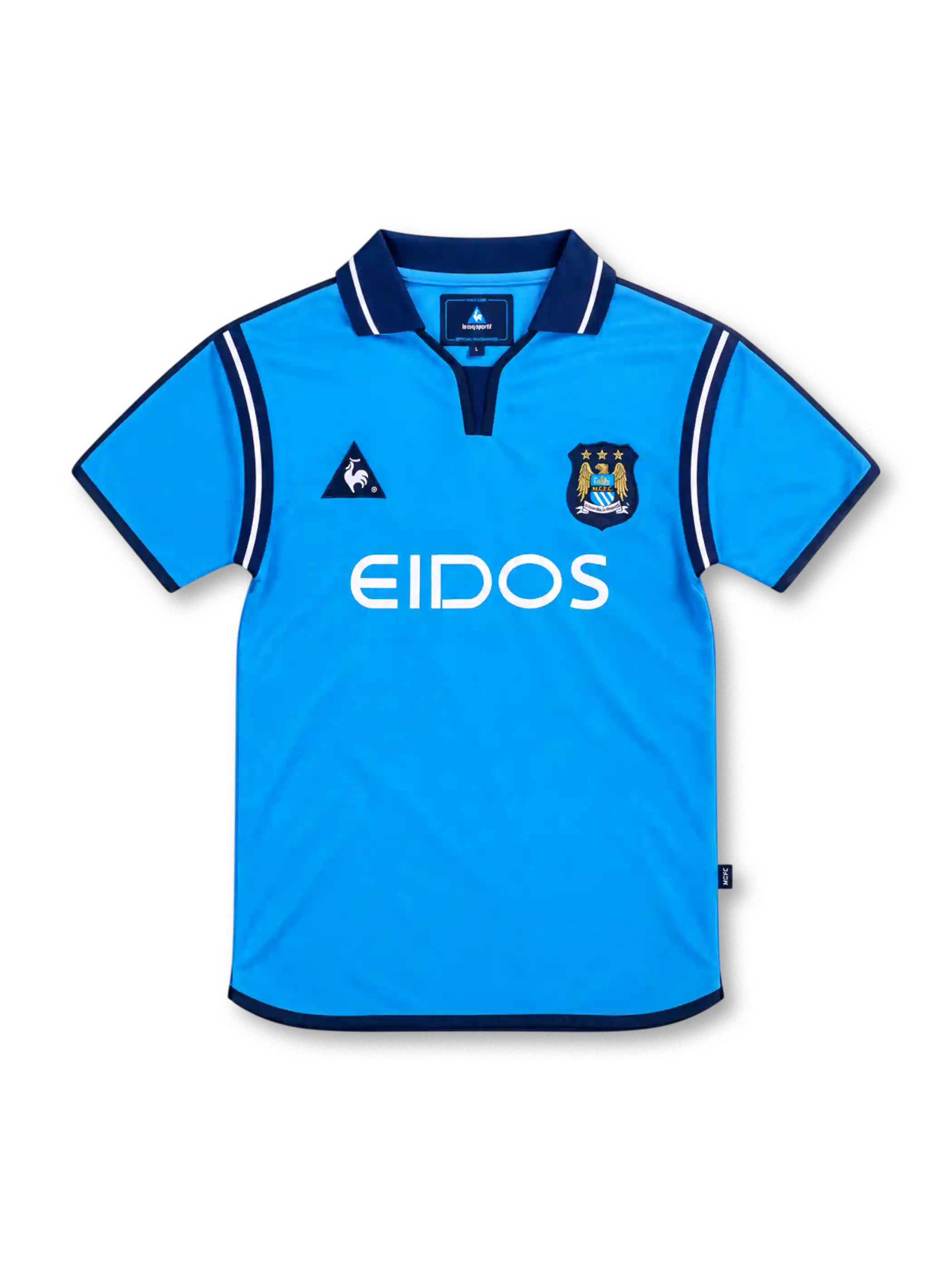 Manchester City 2001/02 sky-blue home jersey with navy polo collar, white EIDOS sponsor, Le Coq Sportif logo and three-star club crest.