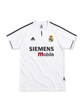 Real Madrid 2003/04 white home jersey with black adidas shoulder stripes, club crest and black-and-red Siemens mobile sponsor.