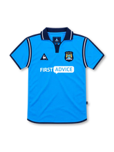 Manchester City 2002/03 sky-blue home jersey with navy collar, white piping, Le Coq Sportif logo, three-star club crest and First Advice sponsor.