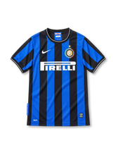 Inter Milan 2009/10 home jersey with black and blue vertical stripes, white Nike Swoosh, Pirelli sponsor, and gold-star club crest.