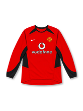 Manchester United 2002–04 red home long-sleeve jersey with black sleeve and side panels, white Nike Swoosh, club crest and Vodafone sponsor.