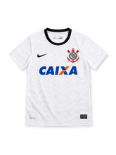 Corinthians 2012/13 white home jersey with black Nike Swoosh, black crew neck, Corinthians crest, blue-and-orange CAIXA sponsor and Dri-FIT branding.