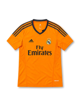 Real Madrid 2013/14 third jersey in bright orange with navy adidas stripes and Fly Emirates sponsor