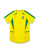 Brazil 2002 yellow home jersey by Nike with green shoulder stripes, curved green side panels, green Nike Swoosh and four-star CBF crest.