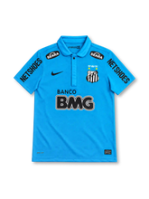 Santos FC 2012 turquoise-blue third jersey with Nike Swoosh, 1912–2012 centenary crest, Banco BMG sponsor, Seara patches and Netshoes sleeve branding.