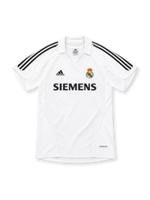 Real Madrid 2005/06 white home jersey with black adidas shoulder stripes, white polo collar, club crest, Siemens sponsor and FORMOTION branding.
