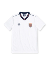 England 1986 white home jersey by Umbro with navy and red V-neck collar, Three Lions crest, black Umbro logo and navy shoulder piping.