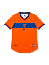 Barcelona 1998/99 orange third jersey with blue horizontal chest stripe, central club crest, navy Nike Swoosh, red-and-navy V-neck and contrasting sleeve cuffs.