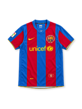 Barcelona 2007/08 home jersey with red-and-blue vertical stripes, yellow Nike Swoosh, UNICEF sponsor, Camp Nou 1957–2007 anniversary crest and La Liga sleeve patch.