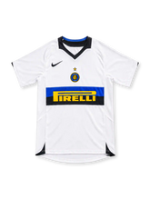 Inter Milan 2005/06 white away jersey with blue-and-black chest band, yellow Pirelli sponsor, black Nike Swoosh, central Inter crest and black V-neck collar.