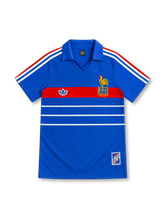 France 1984 royal-blue home jersey with red chest band, white horizontal stripes, tricolor adidas shoulder stripes, yellow FFF rooster crest and commemorative hem patch.