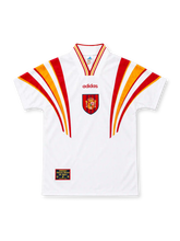 Spain 1996 white third jersey by adidas with sweeping red-and-yellow shoulder stripes, matching striped V-neck collar, red adidas wordmark, central Spanish federation crest and decorative hem patch.