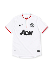 Manchester United 2012/13 white Nike away jersey featuring a red-trimmed Henley collar, red sleeve cuffs, black Nike Swoosh, monochrome club crest, black Aon sponsor and Dri-FIT branding.