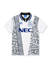Everton 1994/95 white Umbro away jersey featuring black-and-grey abstract geometric graphics, textured vertical panel, black polo collar with blue trim, blue Umbro logo, outlined Everton crest and blue NEC sponsor.