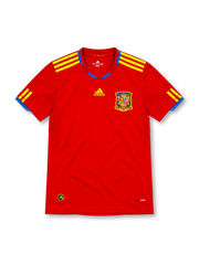 Spain 2010 red adidas home jersey featuring yellow three-stripe shoulder details, blue collar accents and sleeve cuffs, yellow adidas logo, Spanish national team crest, and ClimaCool branding.