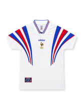 France 1996 white adidas away jersey featuring sweeping blue and red shoulder stripes, tricolor-trimmed V-neck collar, central blue adidas wordmark, gold French Football Federation rooster emblem, and heritage hem patch.