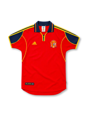 Spain 2000 red adidas home jersey featuring a navy-blue polo collar and shoulder panels, yellow three-stripe details, yellow piping, adidas logo, Spanish national crest, and Authentic Licensed Product hem label.