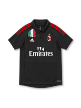 AC Milan 2012/13 black adidas third jersey with red shoulder stripes, black polo collar, Italian tricolor pocket graphic, white adidas logo, gold-star club crest, Fly Emirates sponsor, and ClimaCool branding.