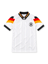 Germany 1992 adidas Equipment home jersey in white with subtle vertical stripes, black red and gold sleeve panels, black V-neck collar with tricolor trim, centered adidas Equipment logo, monochrome German eagle crest, and black sleeve cuffs.