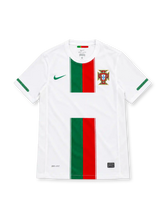 Portugal 2010 white Nike away jersey featuring green and red vertical chest stripes, green Nike Swoosh, Portuguese Football Federation crest, green sleeve detailing, Dri-FIT lettering, and a black Authentic-style hem label.