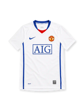 Manchester United 2008/09 Nike away jersey in white with blue V-neck trim, red neckline insert, royal-blue side panels, blue Nike Swoosh, Manchester United crest, boxed blue AIG sponsor, and NikeFIT hem detailing.