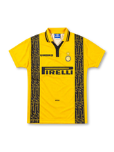 Inter Milan 1996/97 Umbro third jersey in bright yellow with black vertical panels featuring repeated gold F.C. Internazionale script, yellow polo collar with black trim, Inter crest with gold star, black Umbro logo, and Pirelli sponsor.