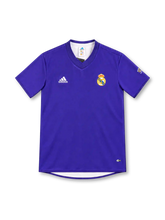 Real Madrid 2002/03 purple adidas third jersey with a solid purple body, tonal V-neck collar, white adidas logo, full-color Real Madrid crest, sleeve emblem, CLIMALITE branding, and a sponsorless front.