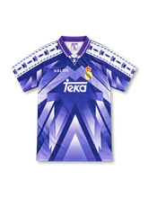 Real Madrid 1996/97 purple away jersey with chevron graphic, paw-print shoulder tape, Kelme logo and Teka sponsor
