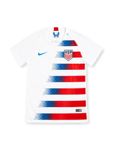 USA 2018 white home jersey with fading blue and red stripes, Nike logo and USA shield crest