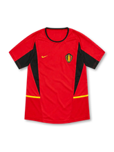Belgium 2002 red home jersey with black angular panels, yellow accents, Nike logo and federation crest