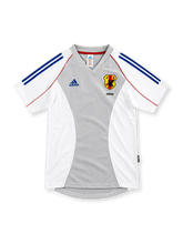 Japan 2002 white and grey away jersey with blue adidas stripes, red piping and JFA crest