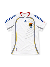 Japan 2006 white away jersey with red collar, blue adidas stripes, grey side panels and JFA crest
