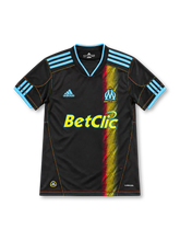 Marseille 2010/11 black away jersey with blue adidas stripes, multicolored vertical graphic, OM crest and yellow Betclic sponsor.
