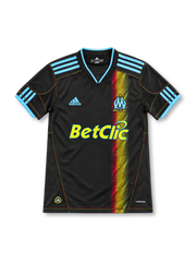 Marseille 2010/11 black away jersey with blue adidas stripes, multicolored vertical graphic, OM crest and yellow Betclic sponsor.