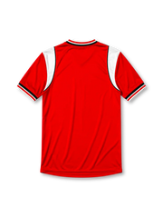 Manchester United 1984-86 home jersey, front view, red body, white sleeve panels with black and red trim, red white and black striped V-neck collar, Umbro diamond logo on sleeves, club crest, SHARP sponsor logo, striped ribbed cuffs