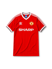 Manchester United 1984-85 home jersey, front view, red body, white V-neck collar with black trim, white adidas three-stripe shoulder detailing, adidas trefoil logo on chest, club crest, SHARP sponsor logo, striped ribbed cuffs