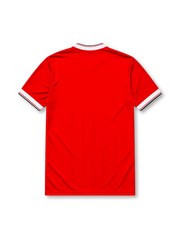 Manchester United 1984-85 home jersey, front view, red body, white V-neck collar with black trim, white adidas three-stripe shoulder detailing, adidas trefoil logo on chest, club crest, SHARP sponsor logo, striped ribbed cuffs