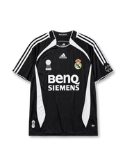 Real Madrid 2006-07 third jersey, front view, black body with white side panels, adidas three-stripe shoulder detailing, FIFA Best Club of the Century emblem, adidas logo, club crest, BenQ Siemens sponsor logo, sleeve patch
