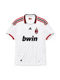 AC Milan 2009-10 away jersey, front view, white body, red and black adidas three-stripe shoulder detailing, point collar with Forza Milan flag tab, adidas logo, club crest with championship star, bwin sponsor logo, red-trimmed cuffs