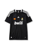 Real Madrid 2008-09 away jersey, front view, black body, white adidas three-stripe shoulder detailing, crew neck collar, Spanish flag patch, adidas logo, club crest, bwin.com sponsor logo, Climacool badge