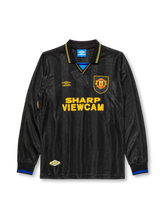 Manchester United 1993-94 away long sleeve jersey, front view, black body with tonal diamond jacquard pattern, gold and blue striped collar, Umbro diamond logo, club crest, SHARP Viewcam sponsor logo, gold and blue diamond cuffs