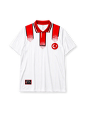 Turkey 1996 Euro away jersey, front view, white body with red paint-splatter shoulder and placket design, red point collar with black and white stripes, adidas wordmark, Turkish Football Federation crest