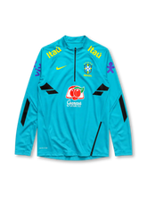Brazil 2022-23 training top, front view, teal body with black geometric panels, quarter-zip funnel collar, Nike swoosh, CBF Brasil crest with five stars, Itaú sponsor text, Guaraná Antarctica sponsor logo, purple sleeve graphics