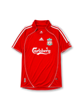 Liverpool 2006-07 home jersey, front view, red body with white piping, funnel collar, adidas three-stripe shoulder detailing, adidas logo, club crest, Carlsberg sponsor logo