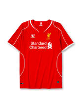 Liverpool 2014-15 home jersey, front view, red body with white piping, V-neck collar, Warrior logo, simplified Liver Bird L.F.C. crest, Standard Chartered sponsor logo